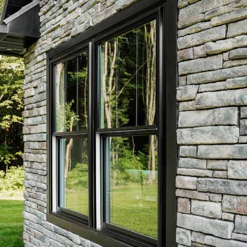 Black casement window stone exterior